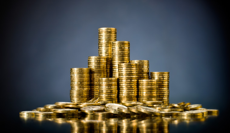 still life of very many rouleau gold  monetary or change coin, on dark blue  background