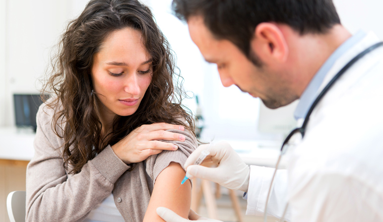 View of a Young attractive woman being vaccinated