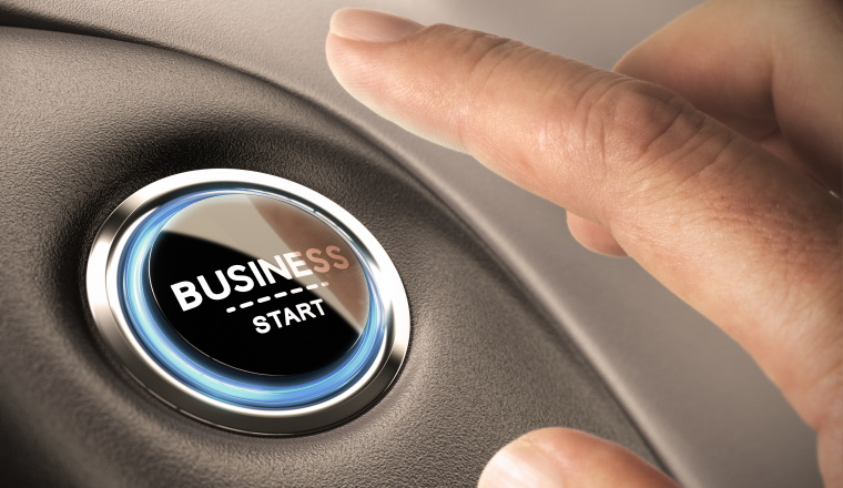 Finger pressing business button. Blue and black tones. Start up concept.