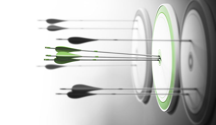 Three targets with focus on the one in the center and arrows hitting the center. Concept of competitive excellence and performance.