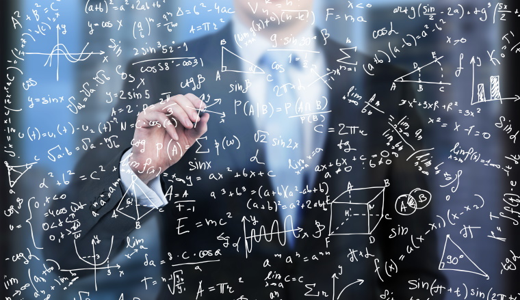 A business person is writing down math formulas on the glass screen in the evening modern panoramic office.