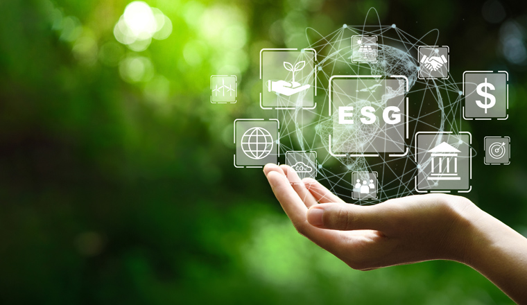 ESG icon concept in the hand for environmental, social, and governance in sustainable and ethical business on the Network connection on a green background.