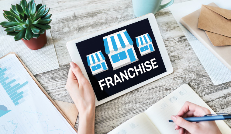 Franchise business model and growth concept on device screen.