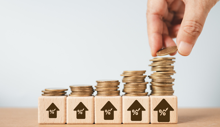 interest rate, business growth, financial, profit, inflation concept. Hand placing coin upward  with percent sign in up arrow  on wooden cube block , growth coin steps