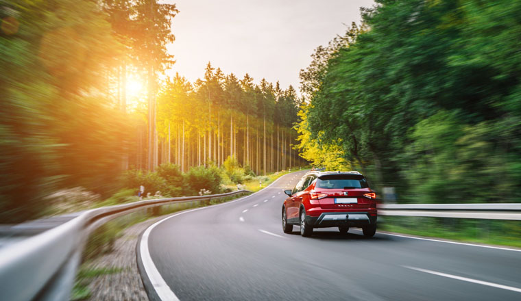 Aachen, Germany - August 26, 2019: Seat Arona small SUV car in european mountain landscape road at sunset