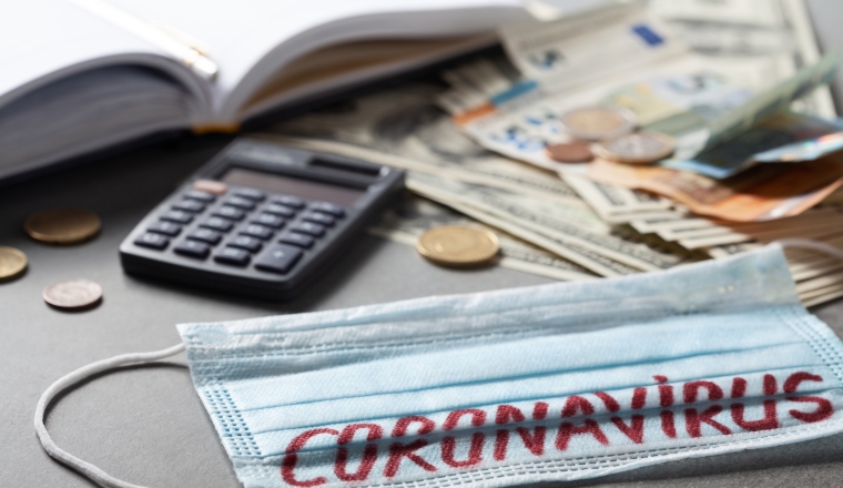 Medical face mask, notebook and money, world coronavirus epidemic and economic damages. Corona virus concept.