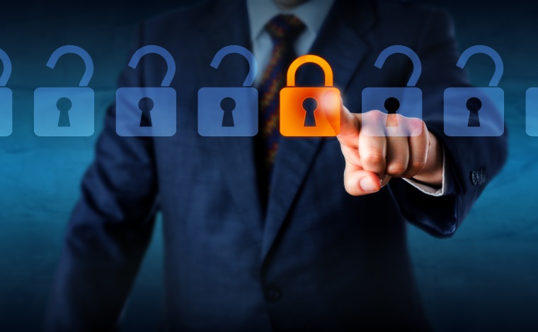 Torso of a manager is locking one virtual lock in a lineup of open padlocks. Business metaphor and technology concept for cyber security, critical data streaming, encryption and personal information.
