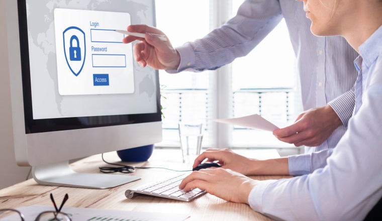 Cyber security concept with manager providing authentication credentials (login, password) to business person to access confidential data on computer screen