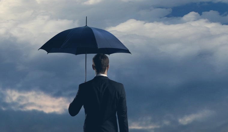Businessman in formalwear over dark dramatic background. Business, finance, career and office concept.