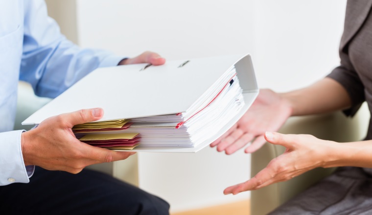 Financial consulting - customer handing over documents to consultant for further analysis