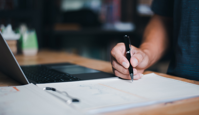The auditor is analyzing his home documents, balance sheet management concept. form validation budget management and management of meeting reports