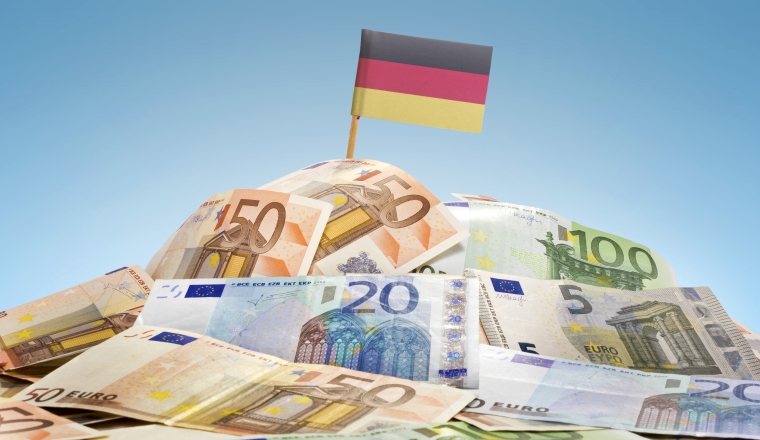 The national flag of Germany sticking in a pile of mixed european banknotes.(series)