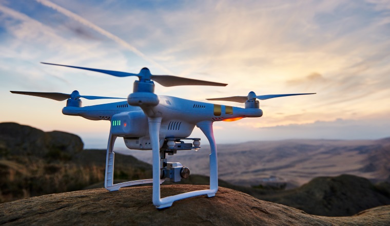 drone with high resolution digital camera ready to fly at sunset in