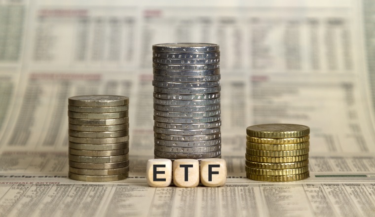 ETF winner's pedestal from coins on a business newspaper
