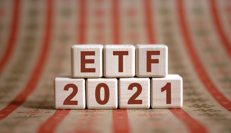 ETF 2021 text on wooden cubes on a monochrome background with reflection.