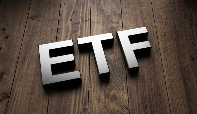 Metallic 3d ETF sign lying obliquely on wooden boards for an interesting header for Exchange Traded Funds with copy space