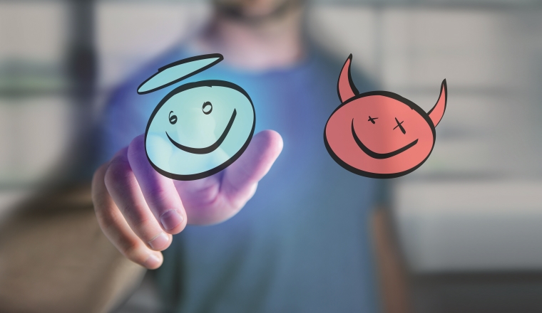 View of a Man finger touching a hand drawn demon and angel icon on a futuristic interface - technology concept