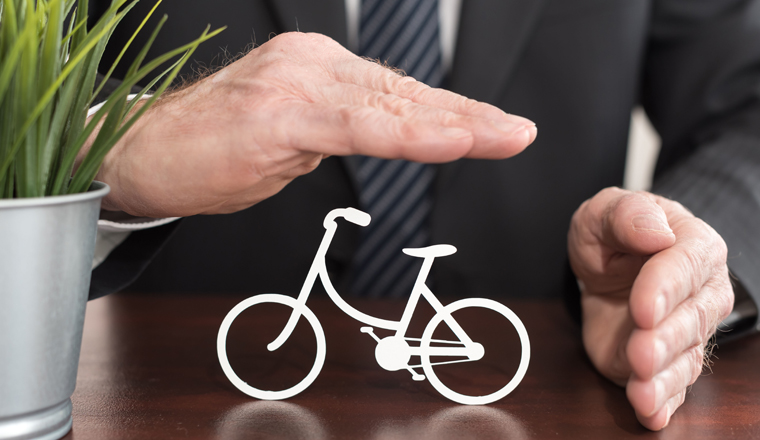 Insurer protecting a bicycle with his hands