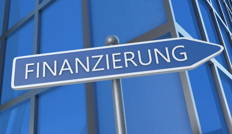 Finanzierung - german word for funding or financing - 3d render text concept illustration with street sign in front of office building.