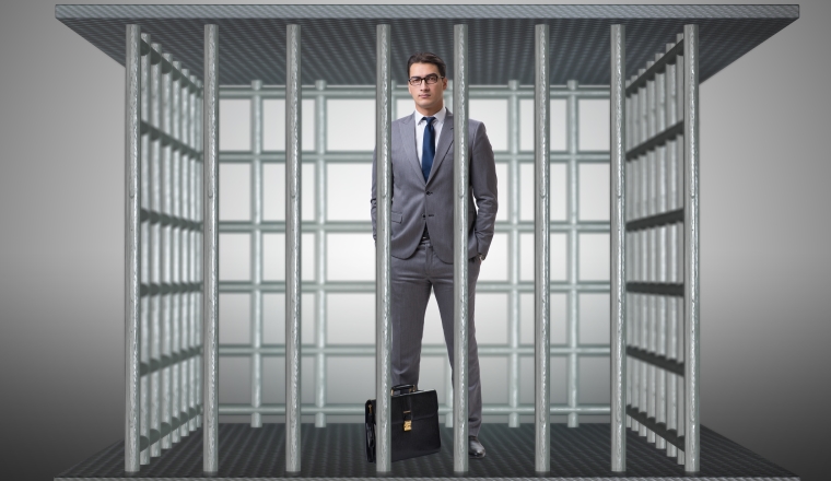 Businessman in the cage business concept