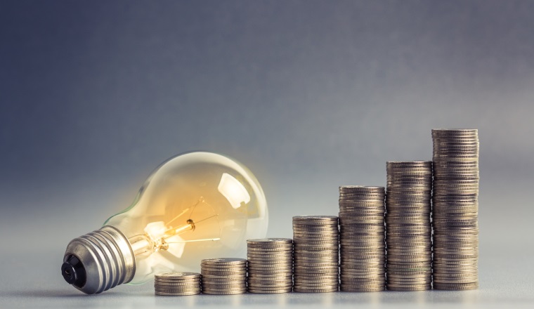 Light bulb with heap of coins stairs for financial plan or business idea concept