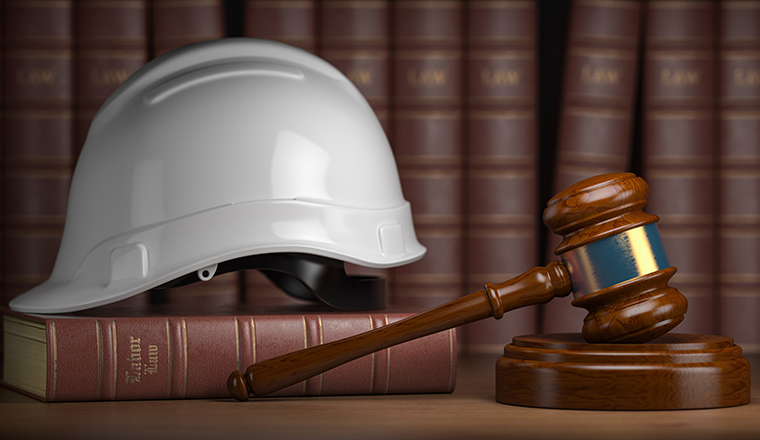 Labor law concept. Gavel  with concstruction hard hat and books. 3d illustration