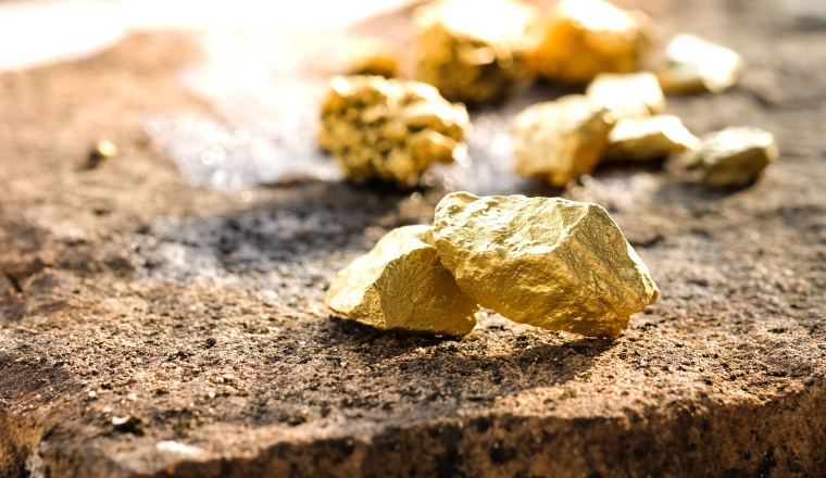 The pure gold ore found in the mine on a stone floor
