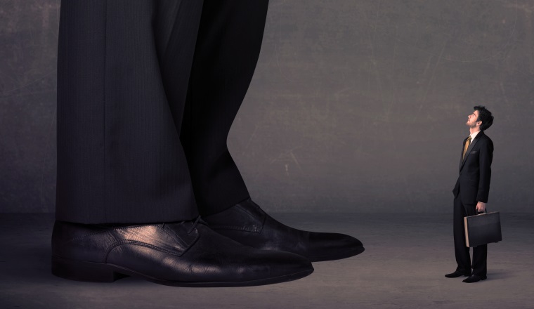 Huge legs with small businessman standing in front concept on background