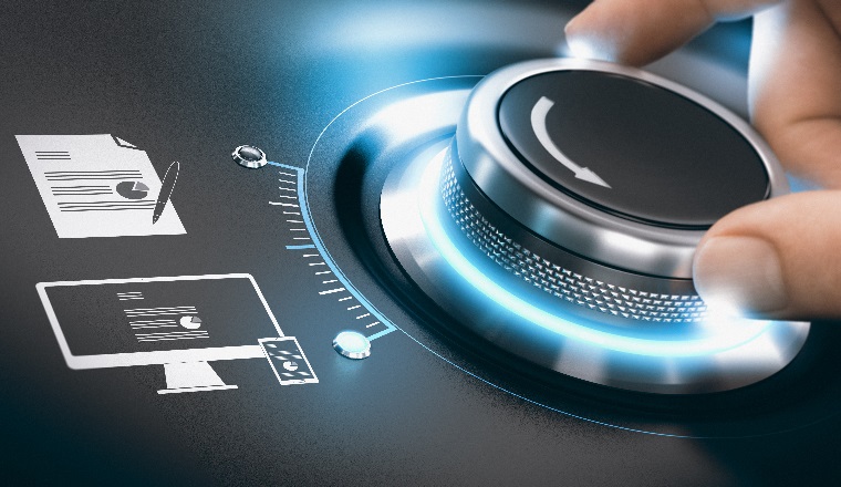 Hand turning a digitization knob to complete the process of digital tansformation of information. Concept of digitalization of analog data over black background. Composite image between a hand photography and a 3D background.