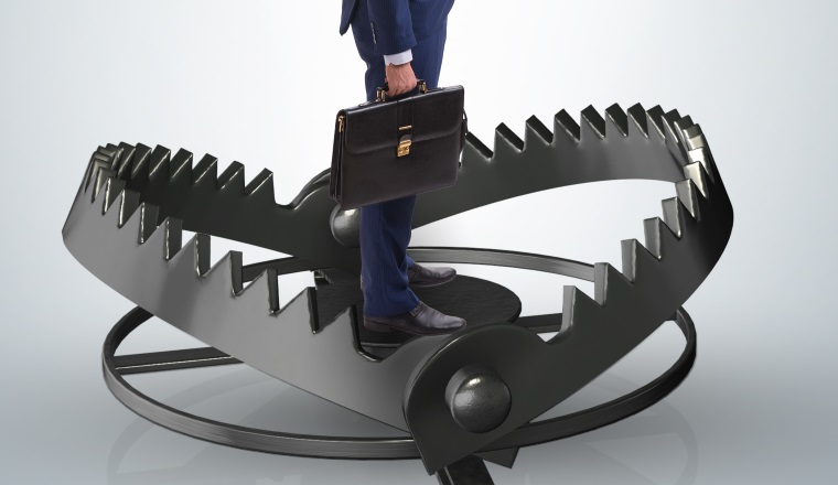 Man caught in mouse trap in risk business concept