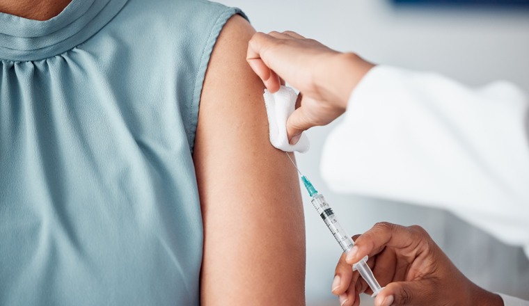 Hands, medical and doctor with patient for vaccine in a clinic for healthcare treatment for prevention. Closeup of a nurse doing a vaccination injection with a needle syringe in a medicare hospital