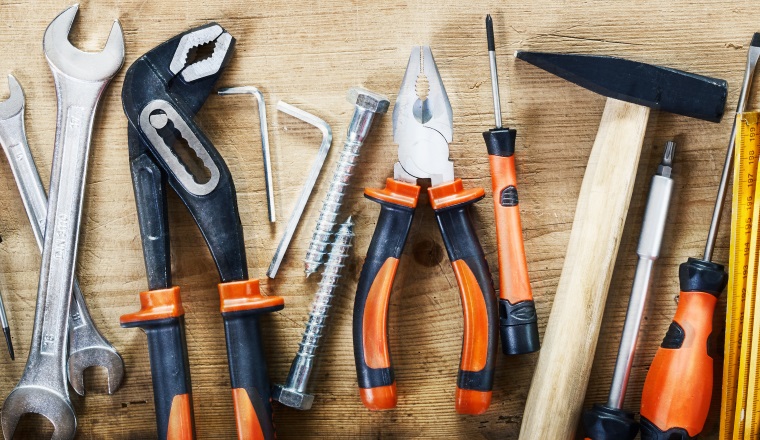 Panorama banner of assorted hand tools on wood for renovations, DIY, building and construction or woodworking
