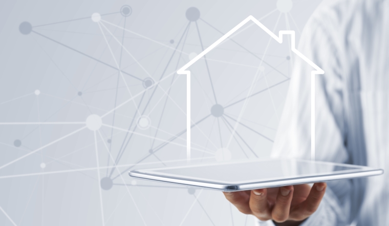 Hand holding modern tablet and house sign on screen