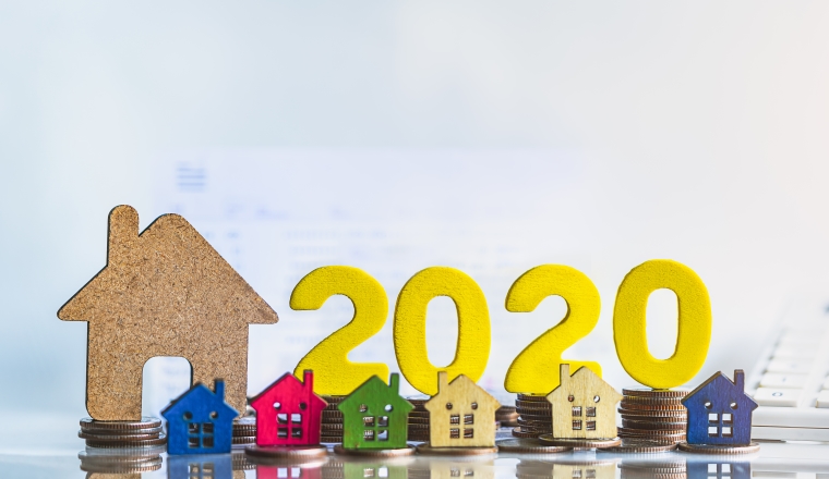House model and wood block 2020. Buying a home with a small family, Affordable housing. Mortgage property insurance dream home concept.real estate agent. Property insurance, security and cozy home concept.