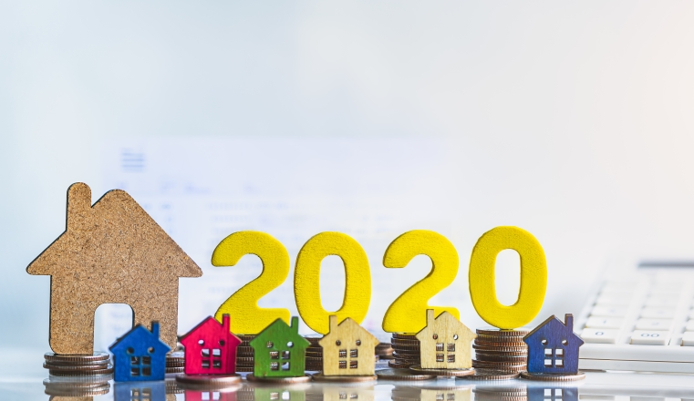 House model and wood block 2020. Buying a home with a small family, Affordable housing. Mortgage property insurance dream home concept.real estate agent. Property insurance, security and cozy home concept.