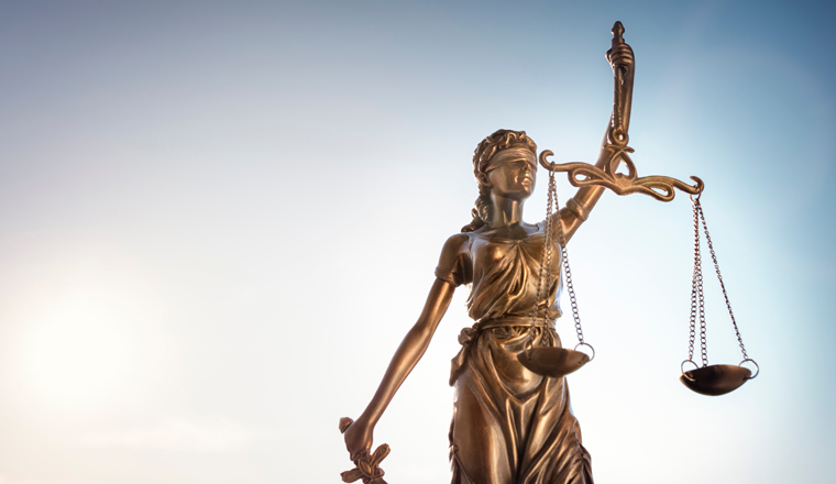 Legal and law concept statue of Lady Justice with scales of justice and sky background