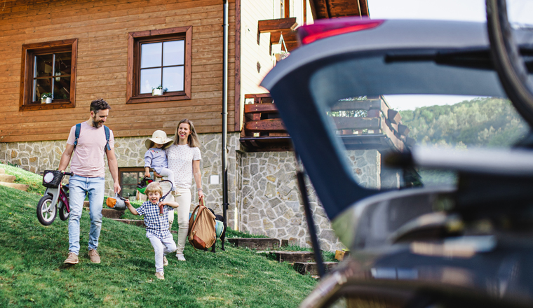 Family with two small children going on cycling trip by car in countryside.