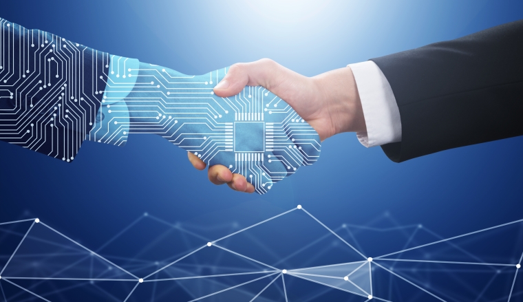 Close-up Of Two Businessman Shaking Hands In Front Of Mallet
