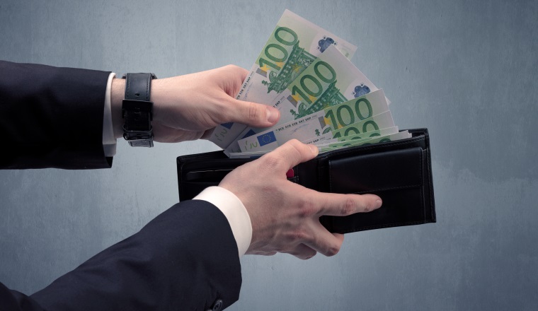 Businessman's hand in suit takes out eruo from his wallet