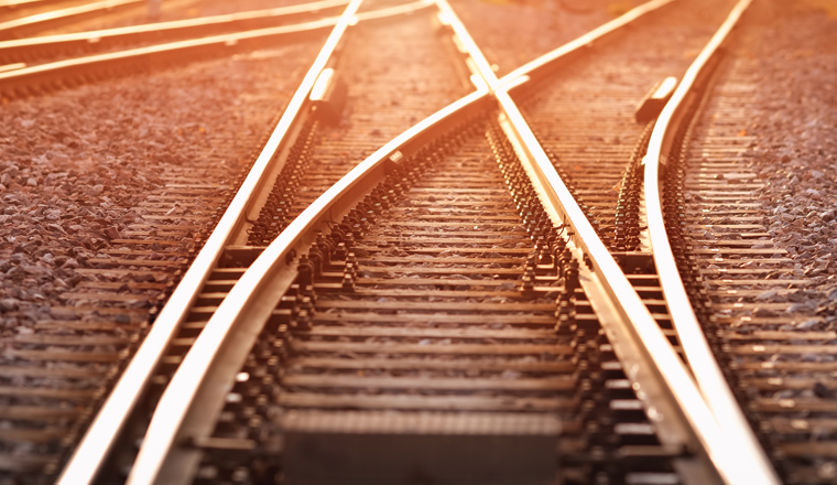 Railway track in the evening in sunset. Panoramic view on the railroad switch.