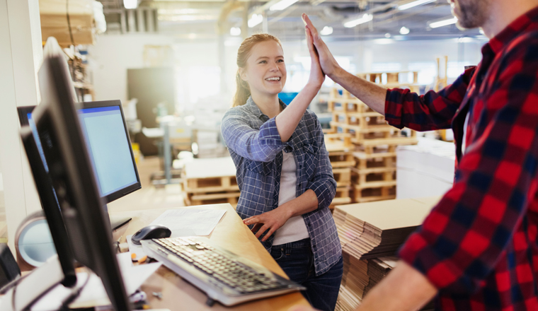 Young caucasian woman reciving positive feedback from colleague