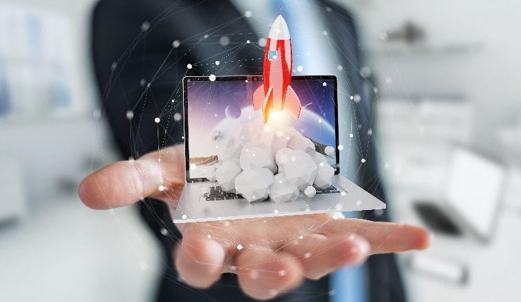 Businessman on blurred background with rocket launching from a laptop 3D rendering