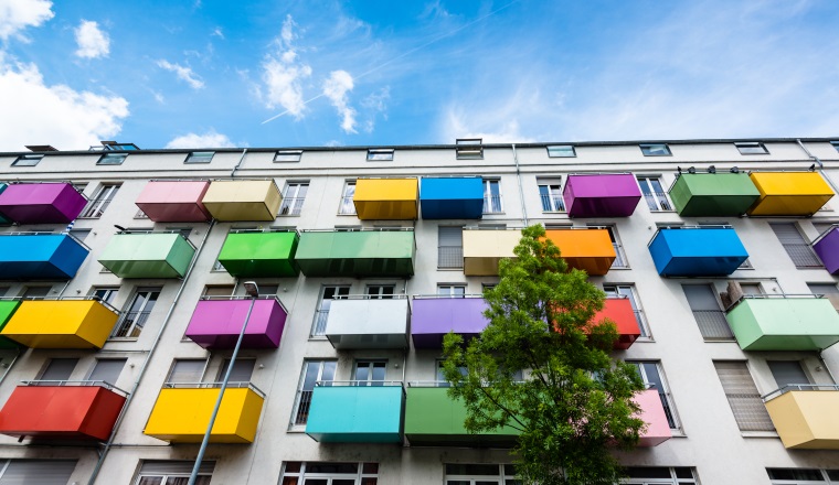 Colorful balconies on a modern apartment building  against great blue sky