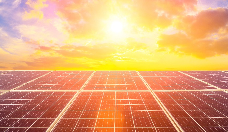 Photovoltaic solar panels on sunset sky background,green clean energy concept.