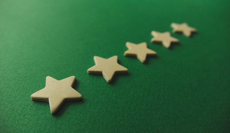 five white stars on a green background.