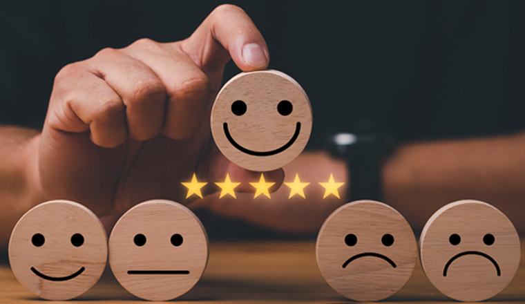 customer services best excellent business rating experience. Satisfaction survey concept. Hand of a businessman chooses a smile face on wood block cube. 5 Star Satisfaction.