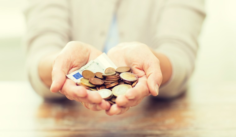 savings, money, annuity insurance, retirement and people concept - close up of senior woman hands holding money jar