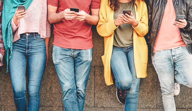 Group of friends using their smart mobile smartphones outdoor - Millennial young people addicted to new technology trends apps - Concept of people, tech, social media, generation z and youth lifestyle