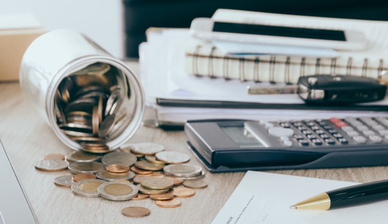 Car insurance concept:Car claim form with car toy crash on desk with Money flow out of jar coin bank.