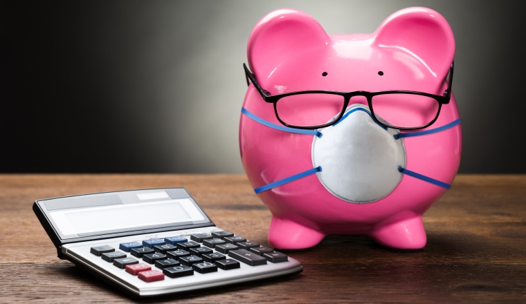 Pink Piggybank With Calculator On Wooden Table